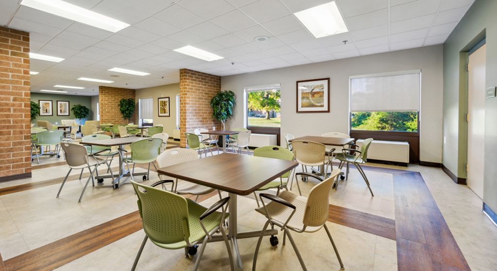 Bright common area with tables and chairs.