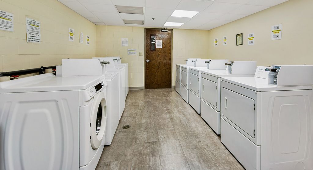 Laundry room with washing machines and dryers