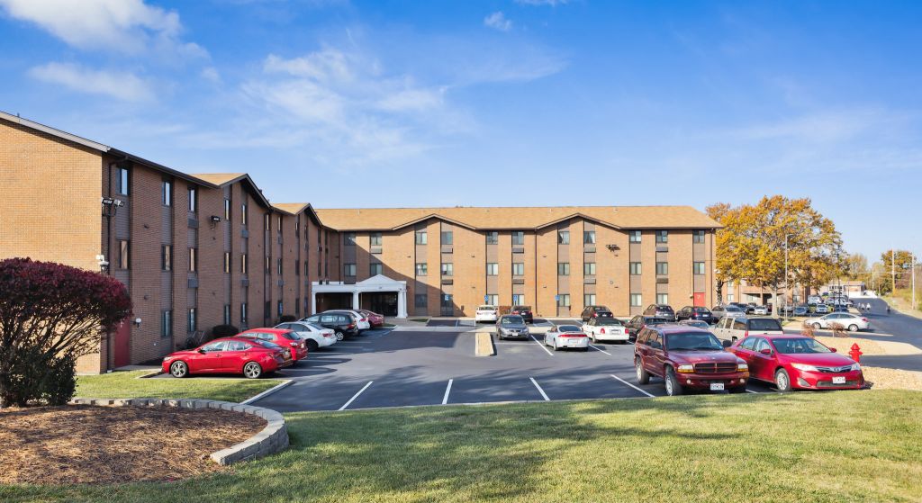 Exterior view of Center Place Senior Apartments parking area.