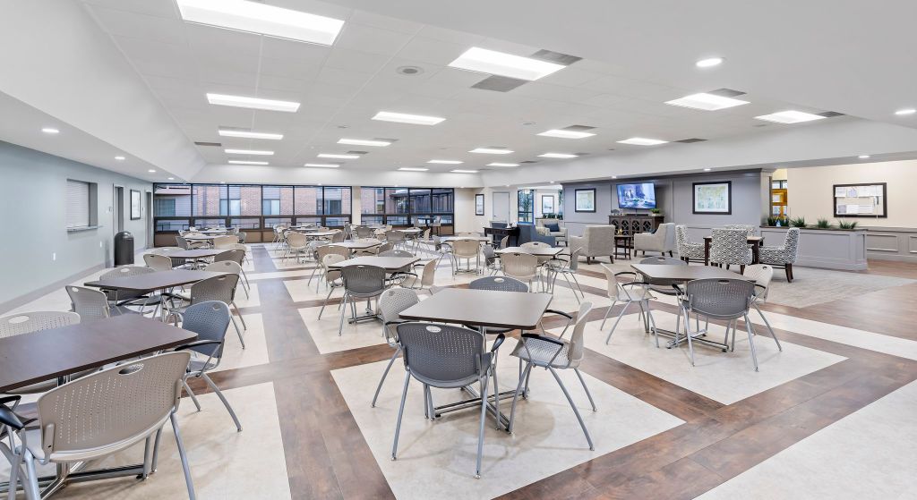 Bright dining area with tables and chairs.