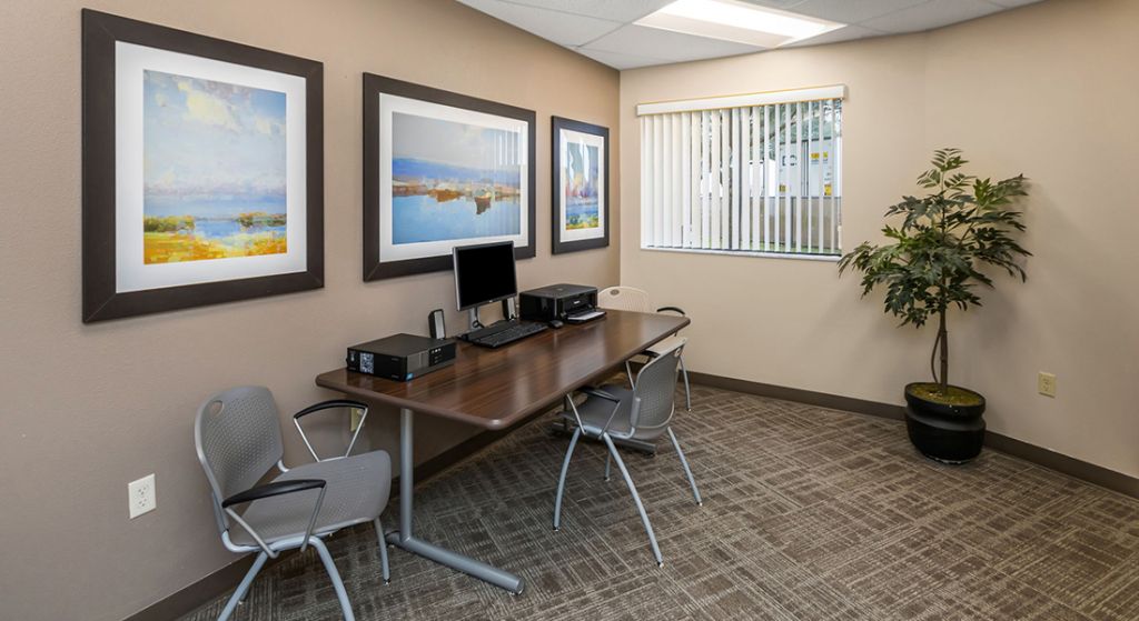 Interior office space with a desk and artwork.