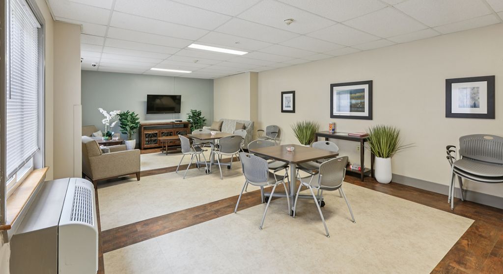 Common area with seating and tables for residents