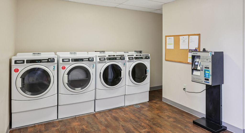 Laundry room with machines and payment station