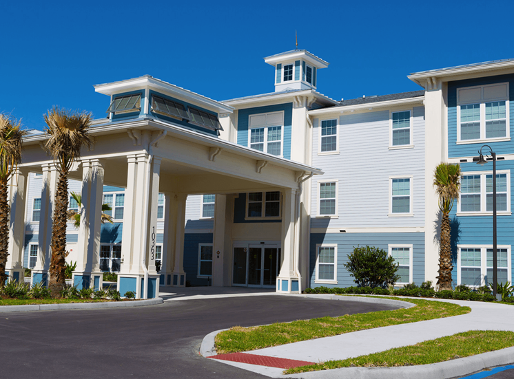 Facade of Madison Reserve Apartments with palm trees