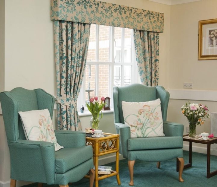 Cozy sitting area with floral curtains and armchairs