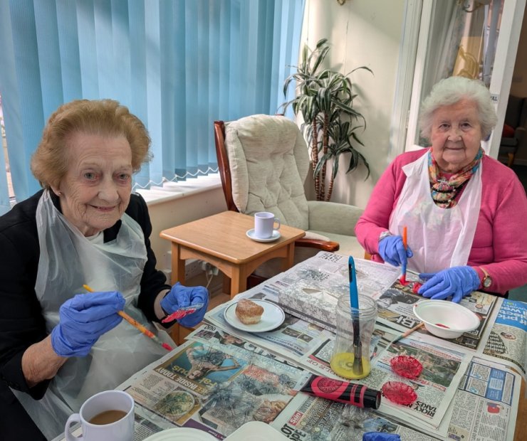 Two residents engaging in an art activity