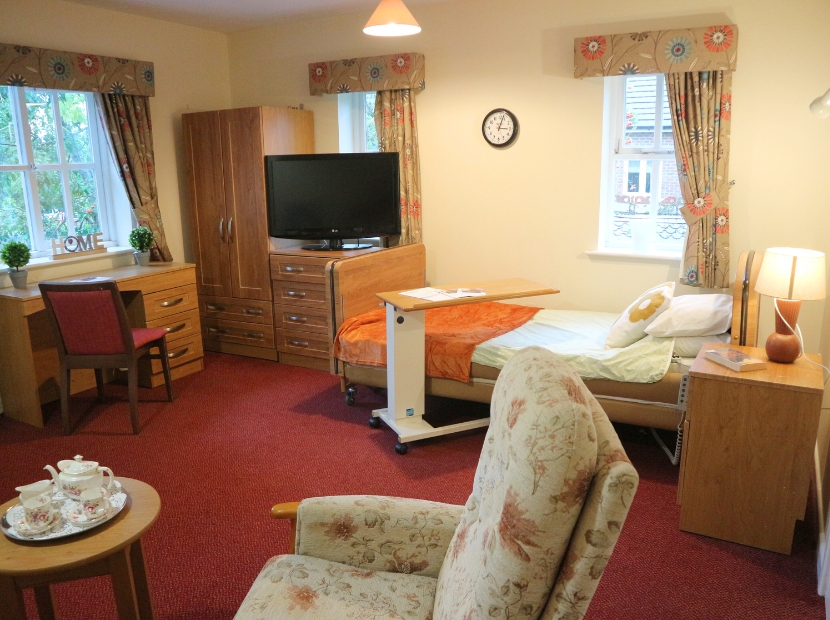 Cozy resident room with furniture and personal touches.