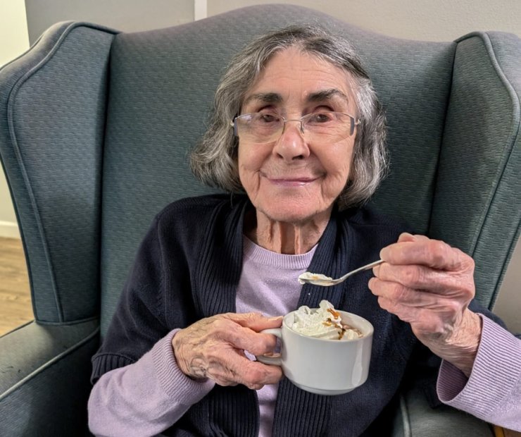 Elderly woman enjoying a dessert