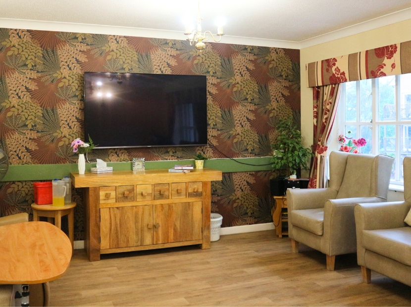 Cozy common area with seating and a TV.