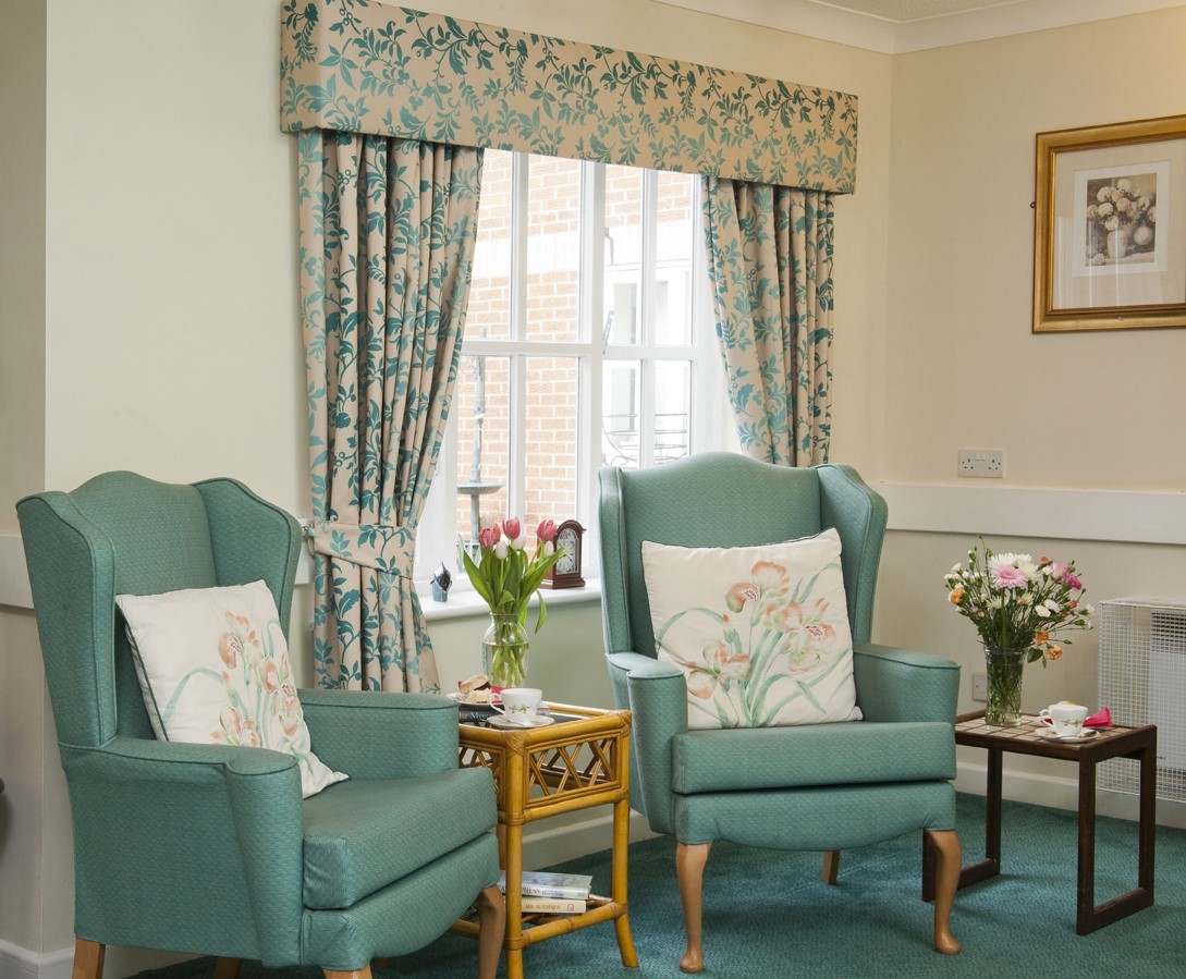Cozy seating area with floral curtains and decor