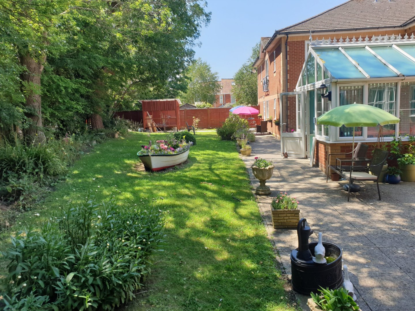 A peaceful garden area with flowers and seating
