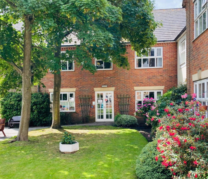 Exterior view of Cedar Court Care Home surrounded by greenery.