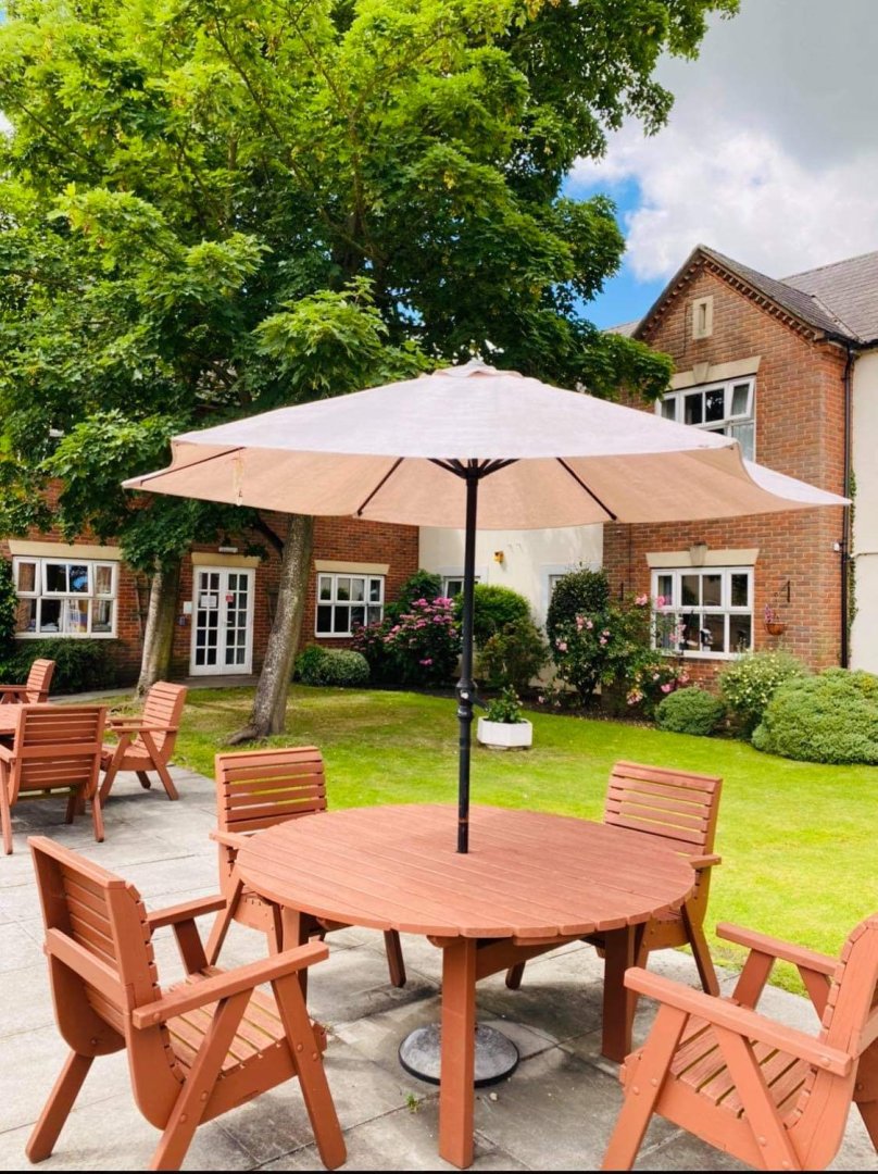 Outdoor seating area with a table and chairs.
