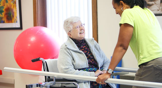 Resident enjoying interaction with staff member.