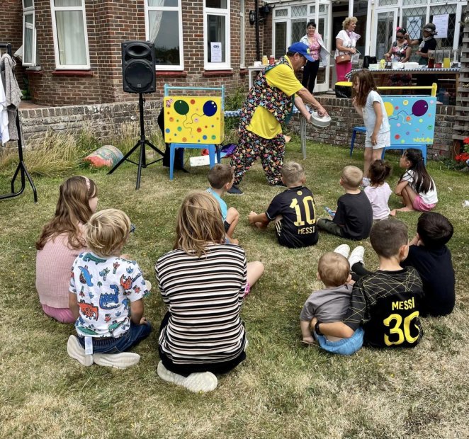 Children enjoying an outdoor entertainment event.