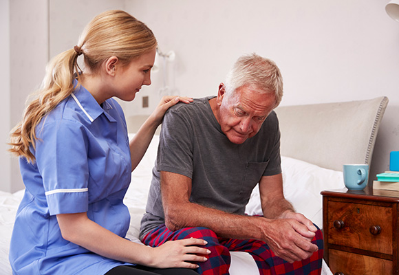 Caregiver assisting a resident in a room
