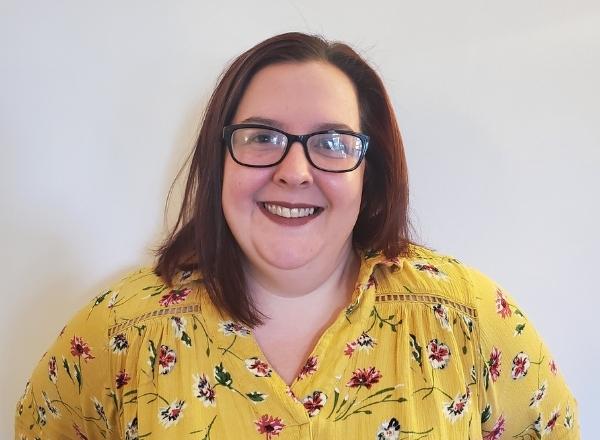 Woman smiling in a floral shirt