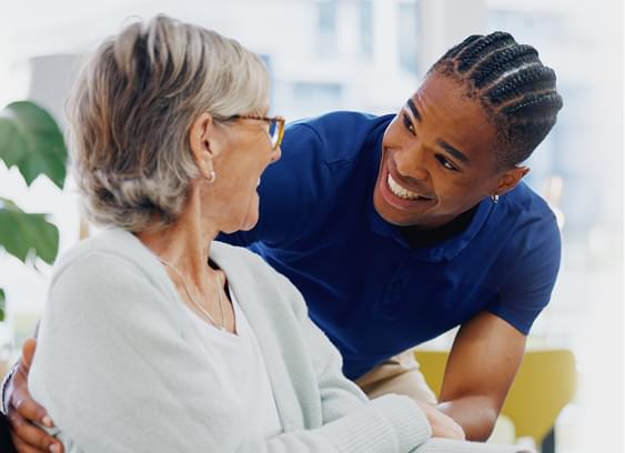 Staff member interacting with a resident in a common area.