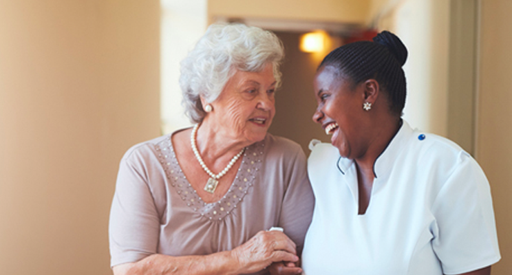 Senior resident and staff member enjoying a conversation