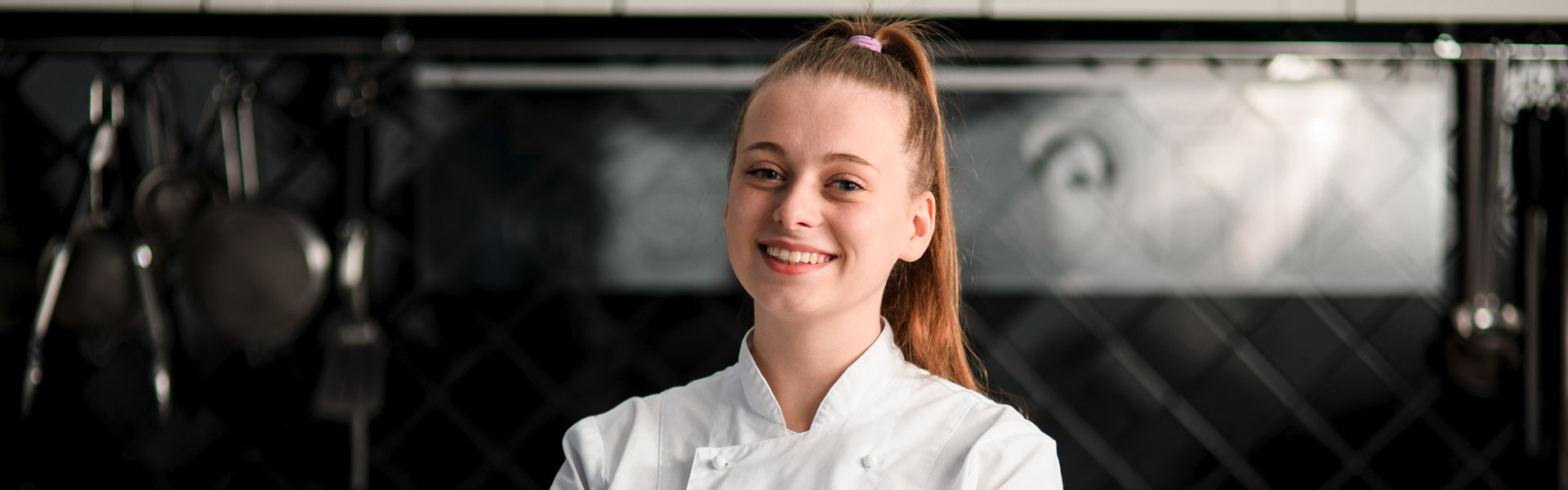 Chef smiling in a kitchen setting