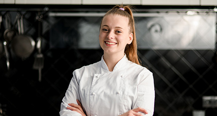 Smiling chef in a kitchen setting