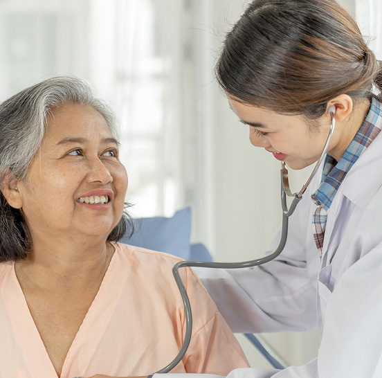 Doctor checking on a smiling senior resident