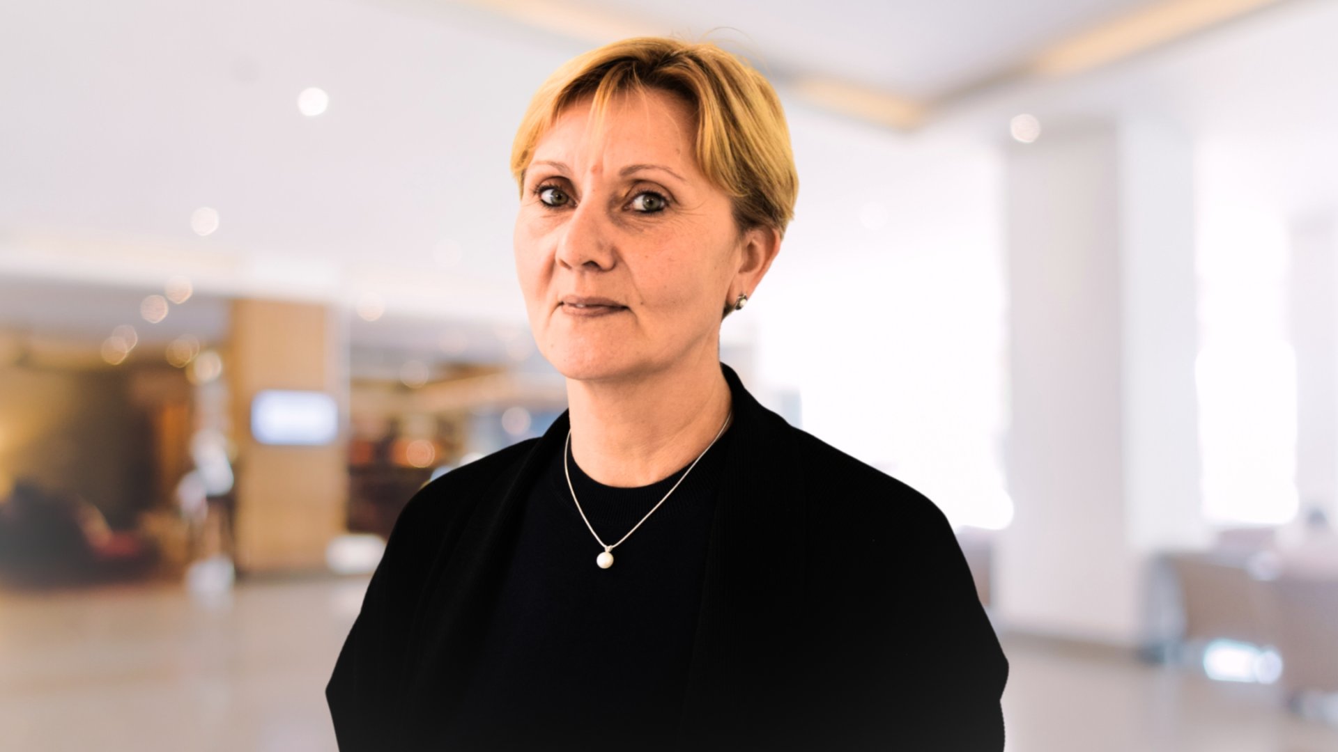 Staff member in a welcoming indoor space
