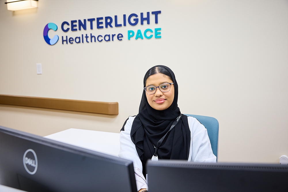 Staff member at reception area in facility.
