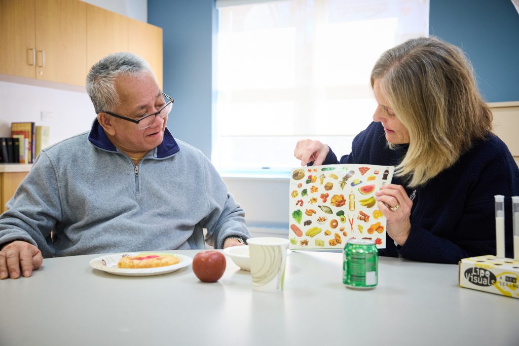 Staff member engaging with resident during an activity.