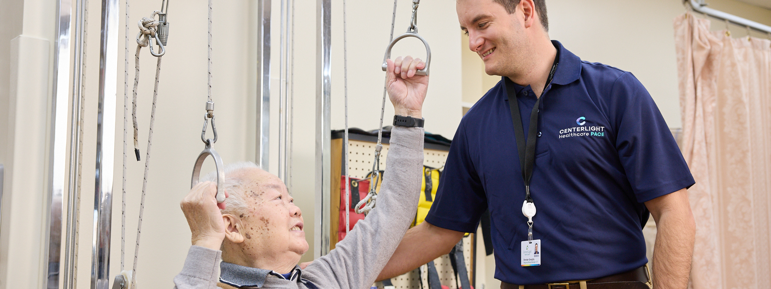 Therapist assisting elderly resident in rehabilitation
