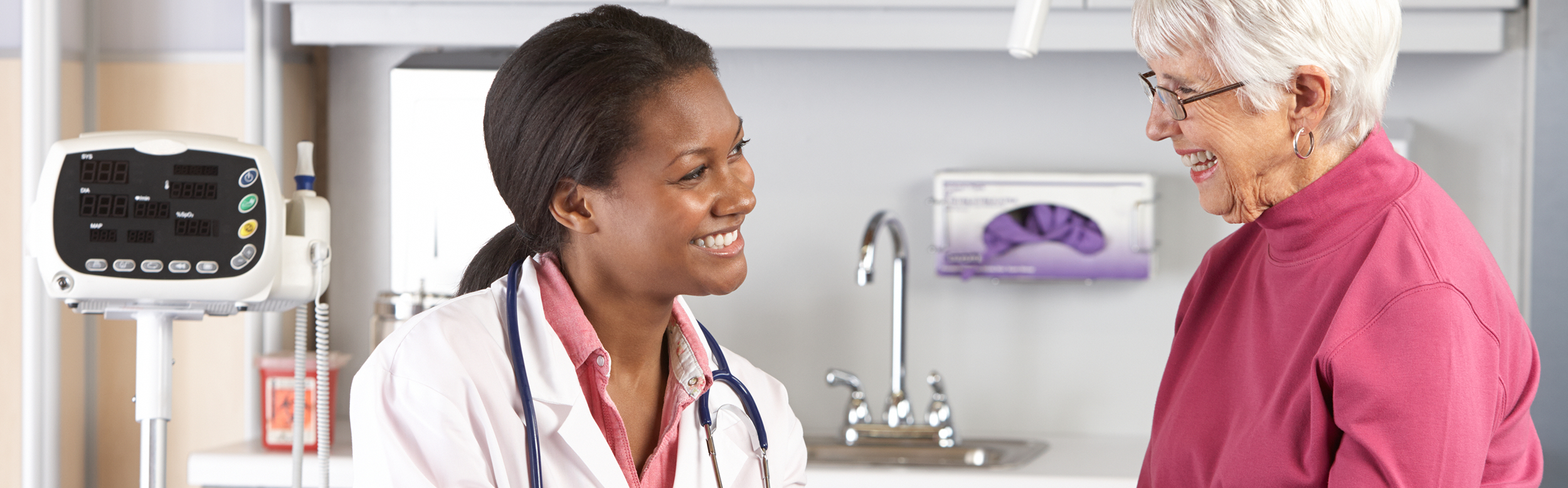 Healthcare professional interacting with senior resident.