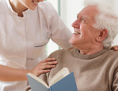Staff member engaging with a senior resident.