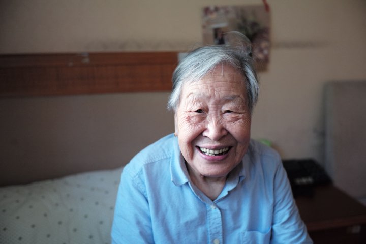 Smiling elderly woman in a senior living room