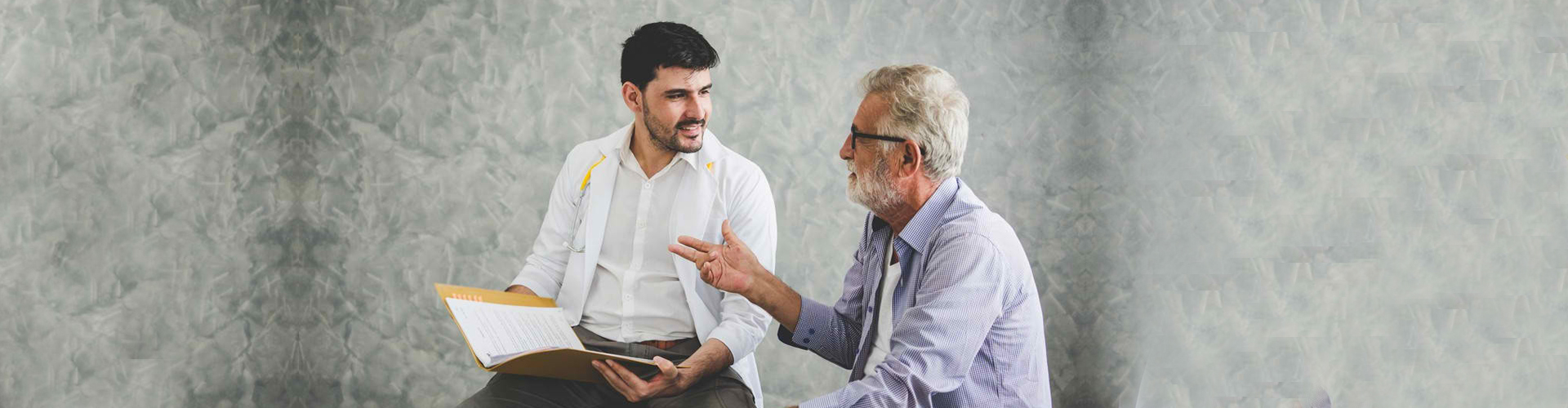 Healthcare professional conversing with a senior resident.