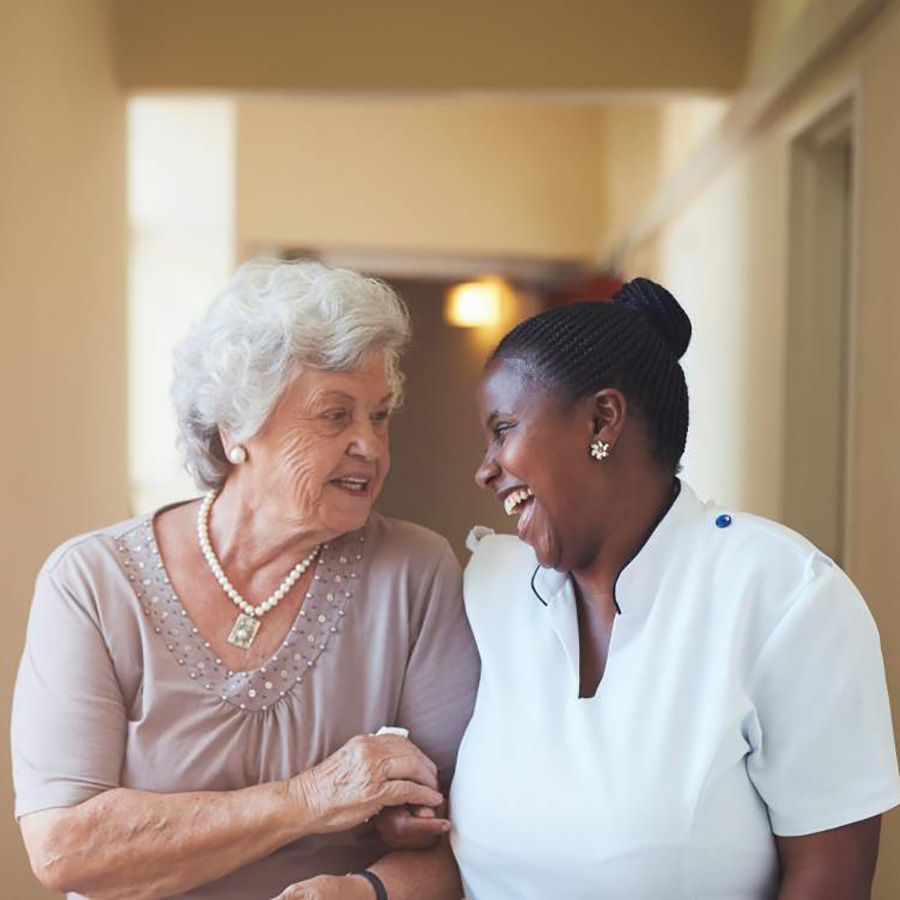 Senior resident and staff member sharing a moment.