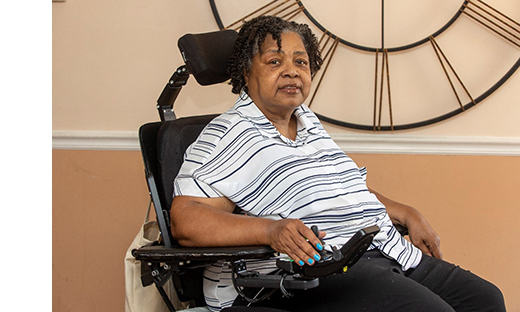 Resident in a mobility chair indoors