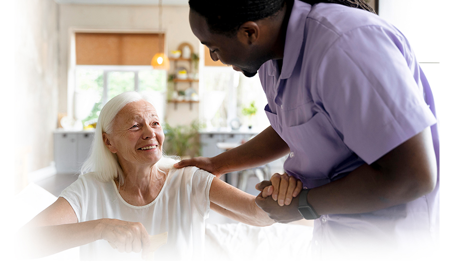 Senior resident interacting with a staff member