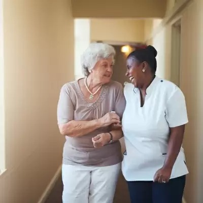 Smiling interaction between a staff member and resident