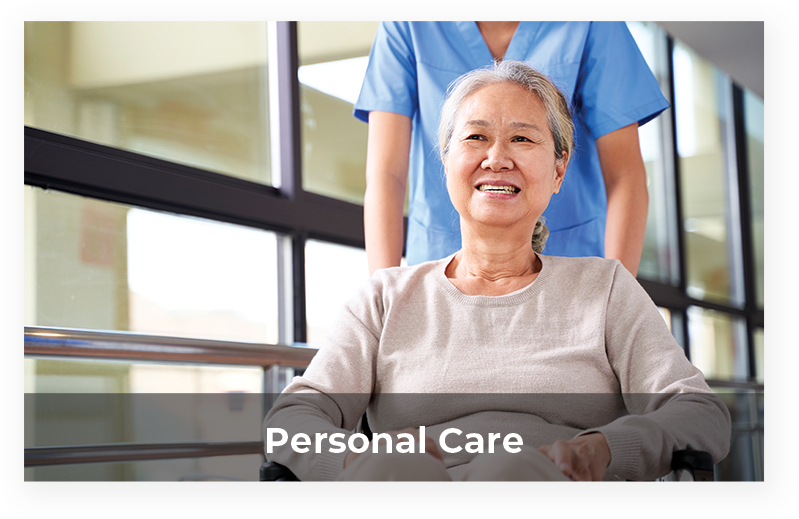 Happy resident in a wheelchair with staff member