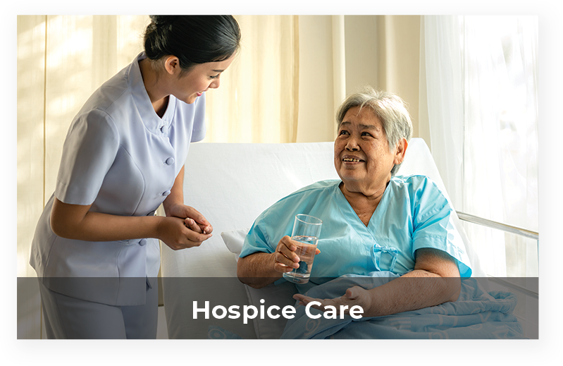 Nurse interacting with smiling resident in a care setting.