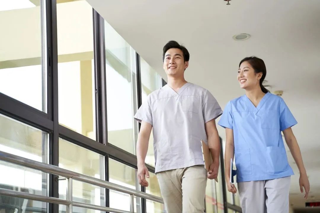 Two caregivers walking in a corridor