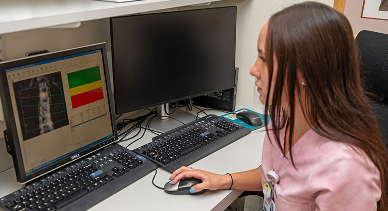 Staff member working at a computer station.