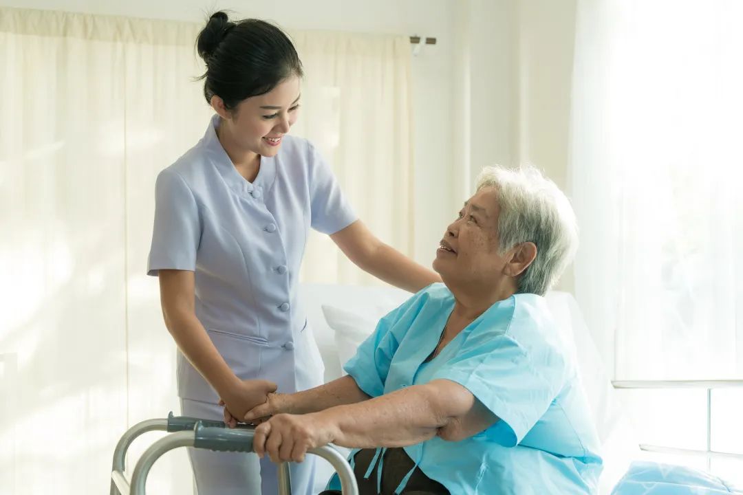 Nurse assisting elderly resident in a care facility