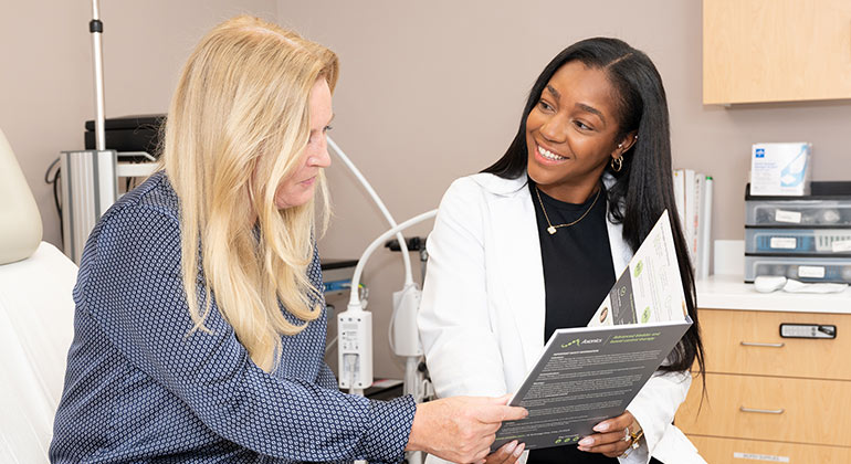 A healthcare professional consulting with a resident.