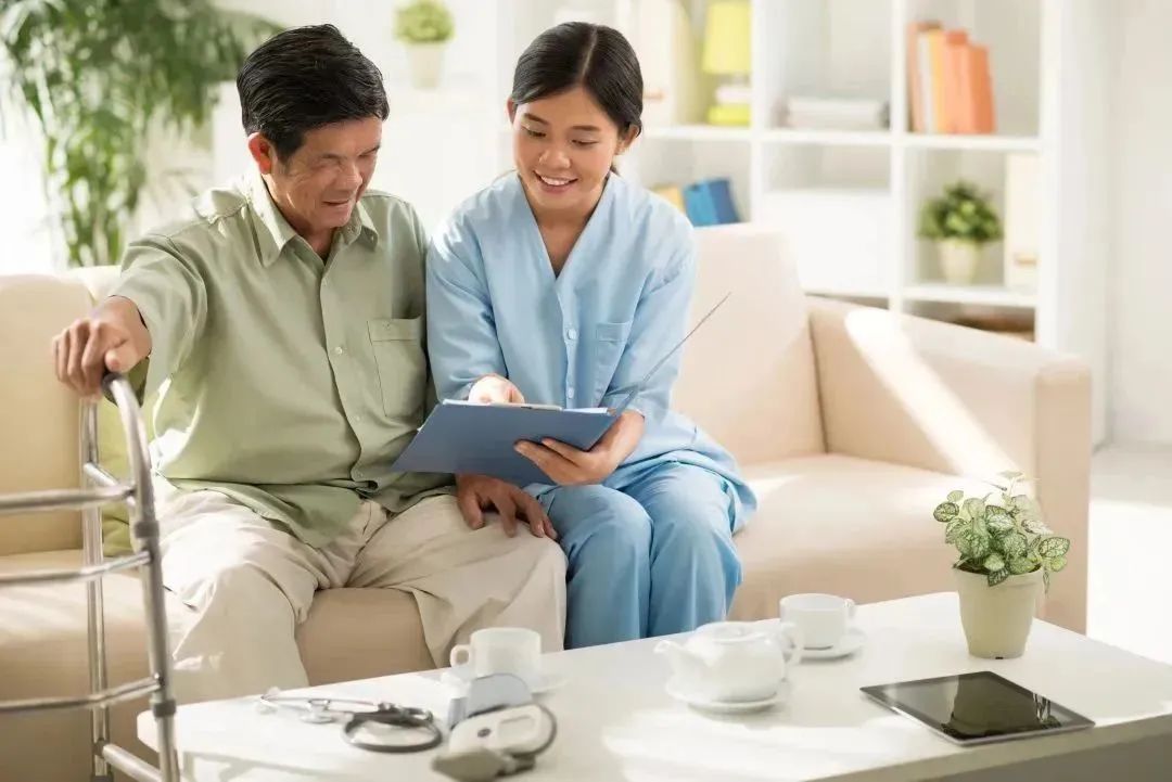 Healthcare worker assisting an elderly man