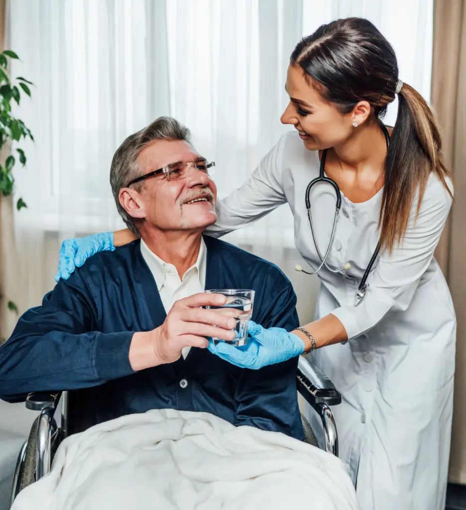 Healthcare worker assisting a resident in a wheelchair.