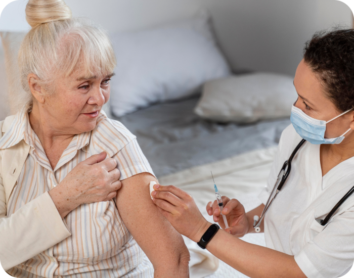 Senior receiving a vaccination from a healthcare worker.