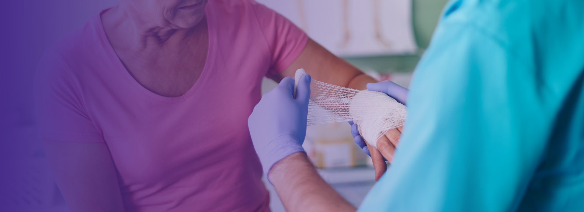 Healthcare professional assisting a senior with a bandage.