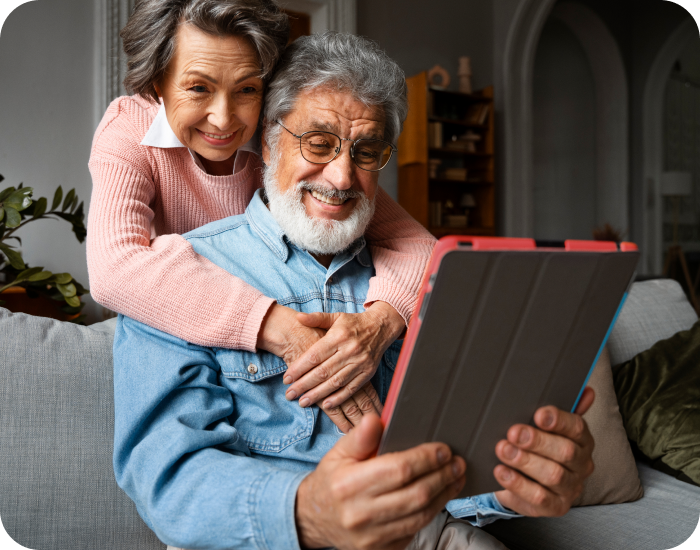 Elderly couple enjoying time together with a tablet.