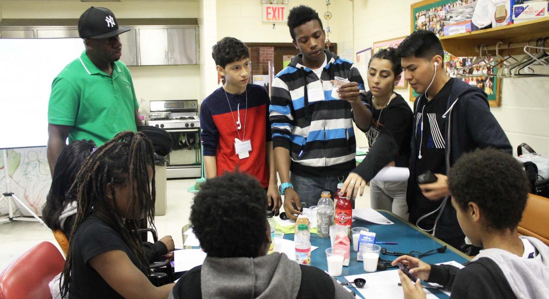 Group of young people engaged in an activity indoors.